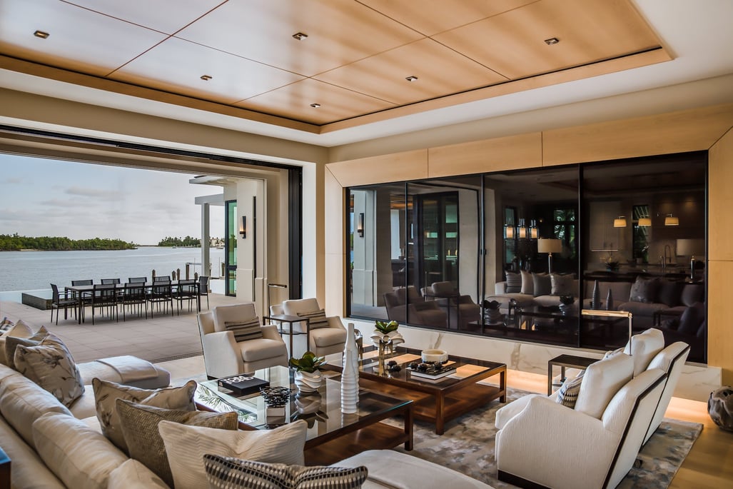 living room with multiple seating options with open windows looking out to the water