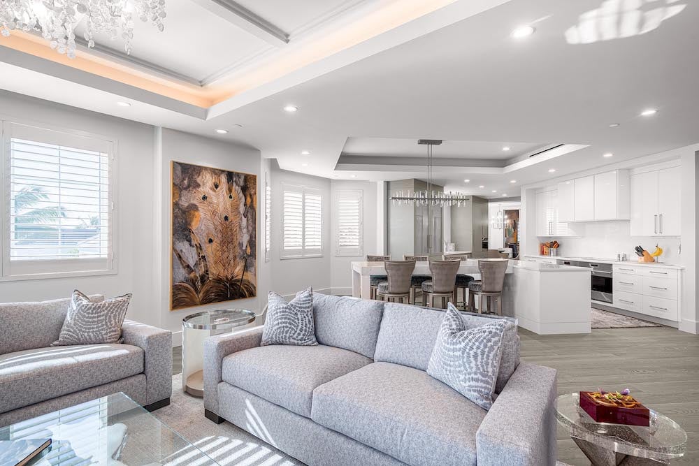 cozy living room with a white couch and kitchen in the background