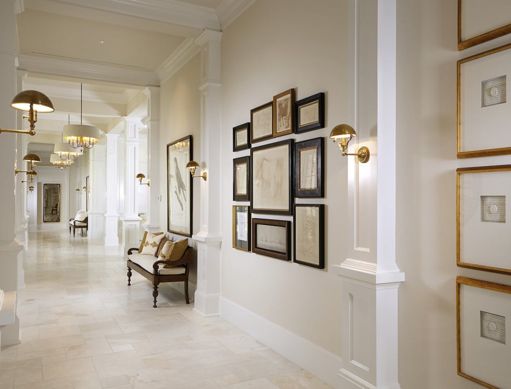 This luxury custom home features a cool transitional gallery wall by Romanza Interior Design.