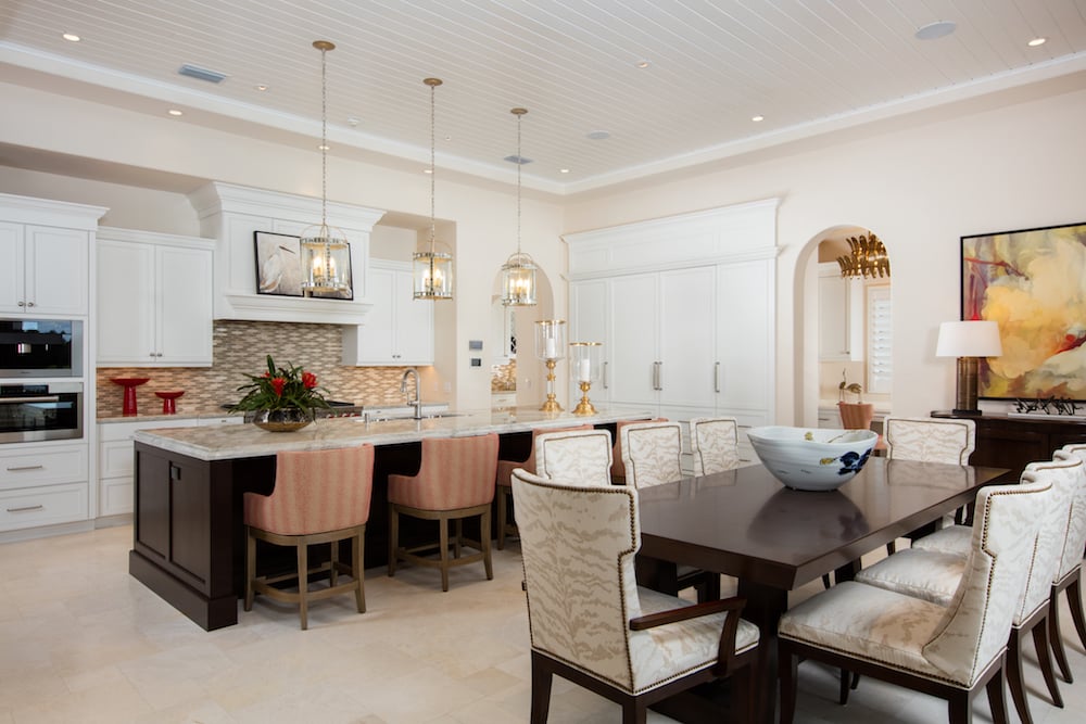 beautiful kitchen with tan accents and a dining table and island