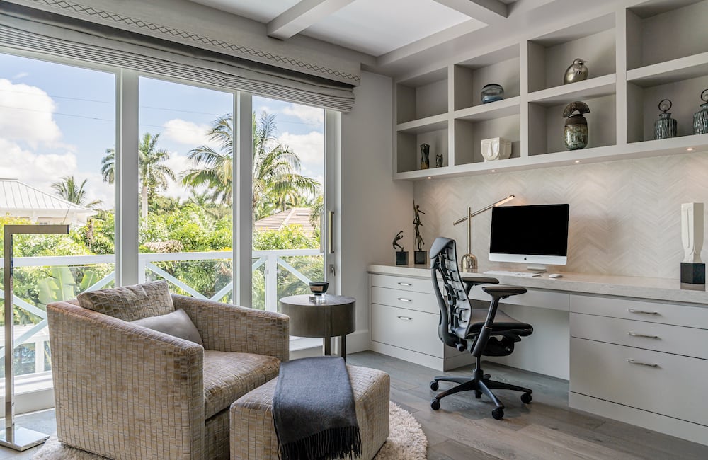 home office on the second story of a home looking outside to palm trees