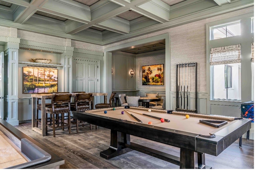 billiards room with a nice billiards table and a bar behind it
