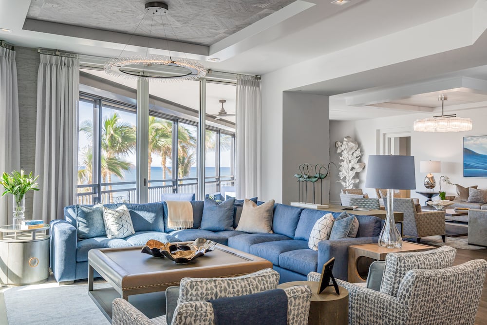 living room with couch that has coastal blue accents and a brown coffee table in front