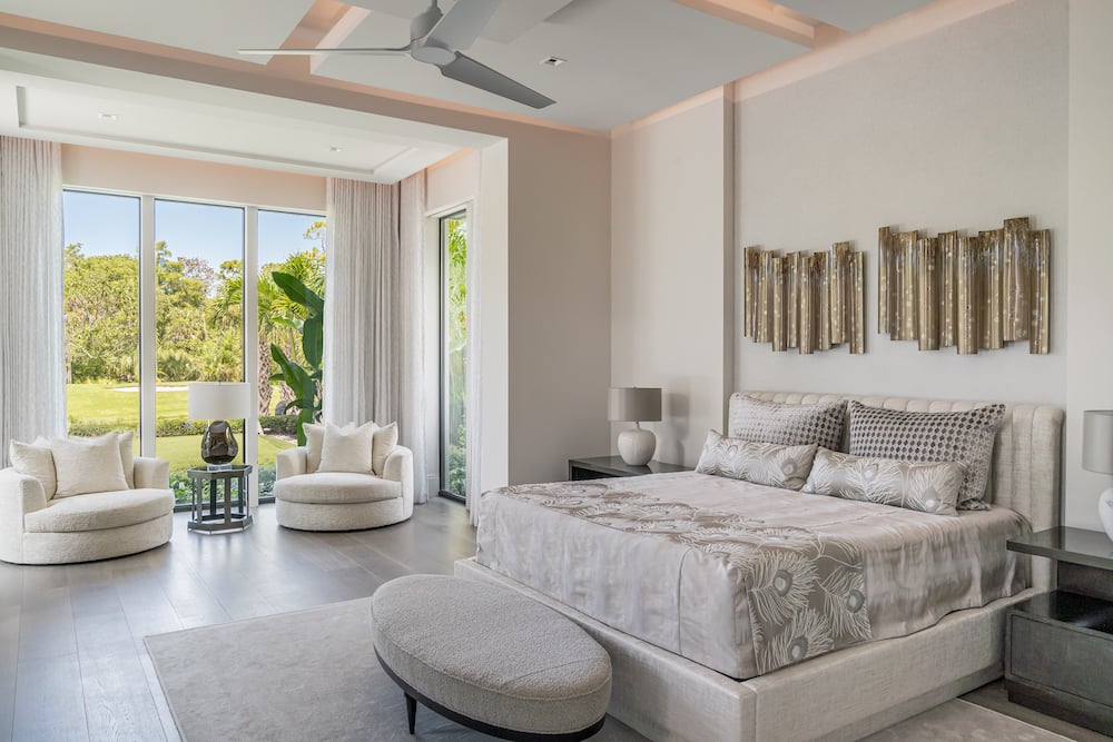 bedroom with white bed and accents, open window looking out onto a golf course