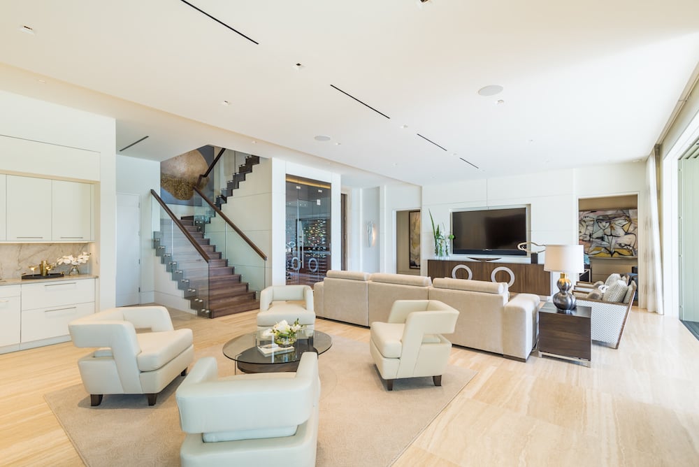 The great room of this Port Royal estate home features glass and wood pieces for an elegant contemporary design.